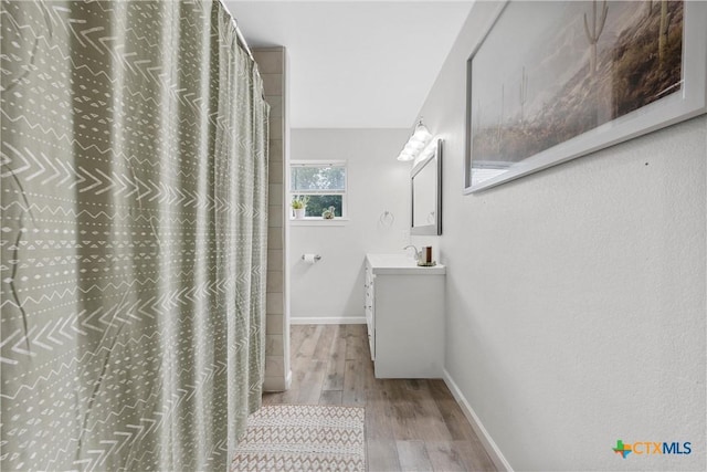 7031 Steinbeck Bend Dr, Waco, TX 76708 - bathroom featuring wood finished floors, vanity, and a shower with curtain