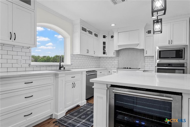7031 Steinbeck Bend Dr, Waco, TX 76708 - kitchen featuring beverage cooler, stainless steel appliances, white cabinets, decorative backsplash, and recessed lighting