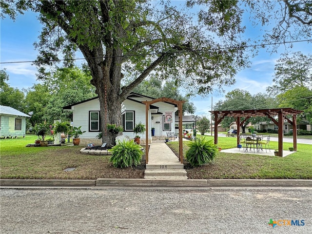 view of front of property with a pergola and a front yard