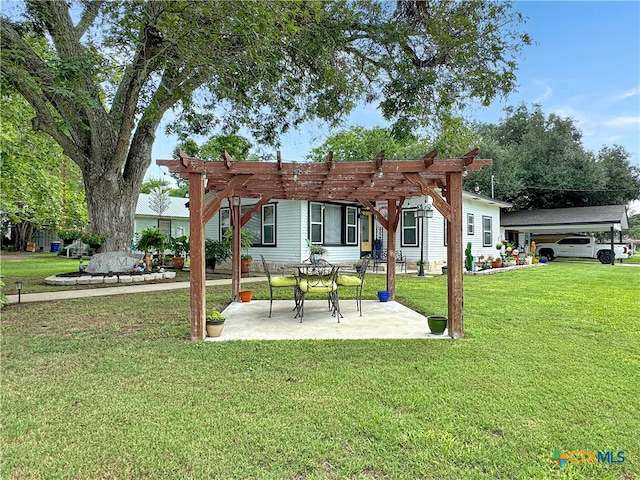 back of property featuring a carport, a yard, a pergola, and a patio area