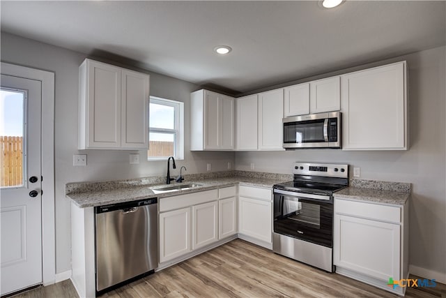 kitchen with white cabinetry, sink, and appliances with stainless steel finishes