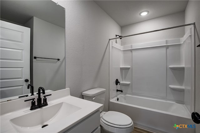 full bathroom featuring vanity, a textured ceiling, toilet, and bathtub / shower combination