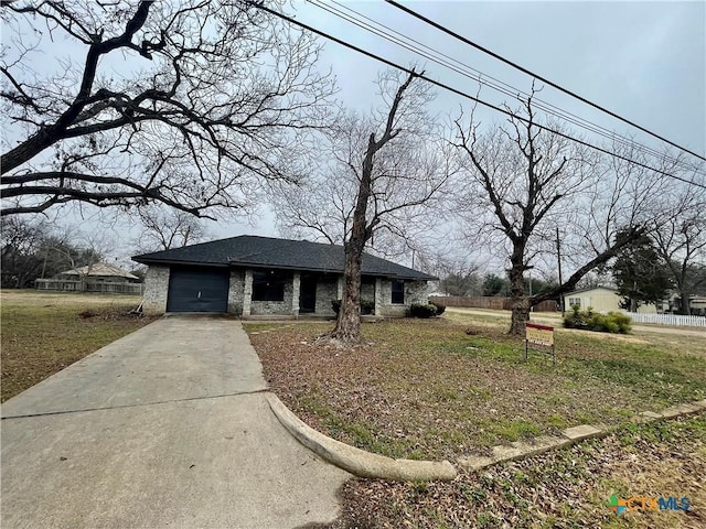 view of front of house with a garage, driveway, and roof with shingles