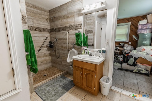 216 Prospect St, Seguin, TX 78155 - bathroom with vanity, tile patterned floors, and a tile shower