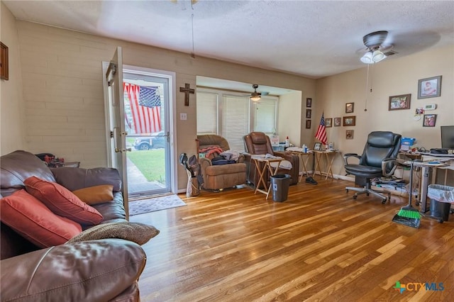 216 Prospect St, Seguin, TX 78155 - living area featuring light wood-style floors, a ceiling fan, a textured ceiling, and a wealth of natural light