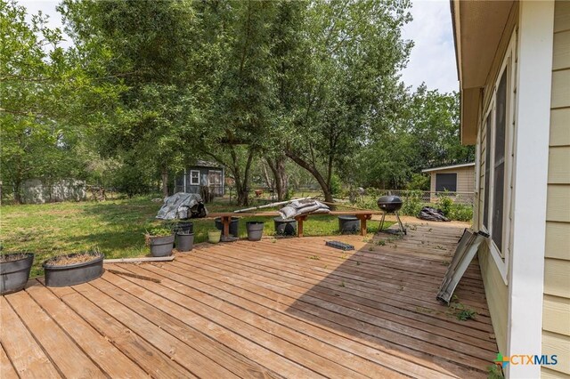 216 Prospect St, Seguin, TX 78155 - wooden terrace with a lawn, fence, an outbuilding, and a storage unit