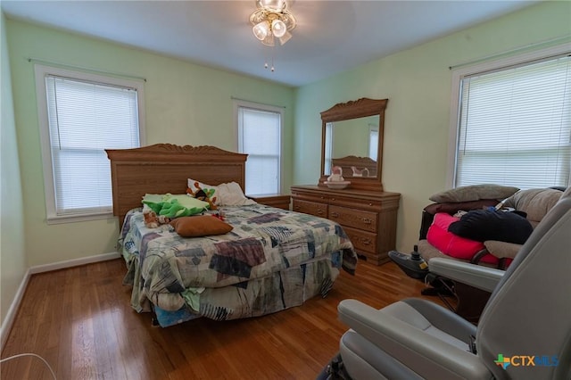 216 Prospect St, Seguin, TX 78155 - bedroom with baseboards, wood finished floors, and multiple windows
