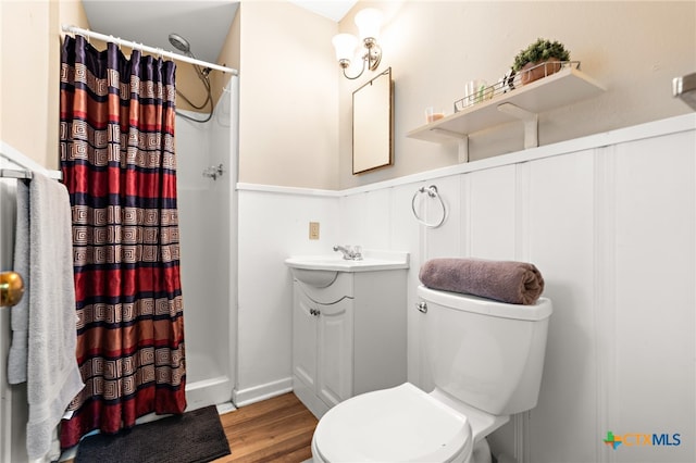 bathroom featuring hardwood / wood-style floors, vanity, toilet, and a shower with curtain