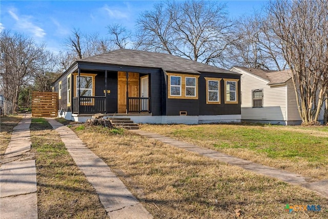 bungalow-style home with a front yard and covered porch