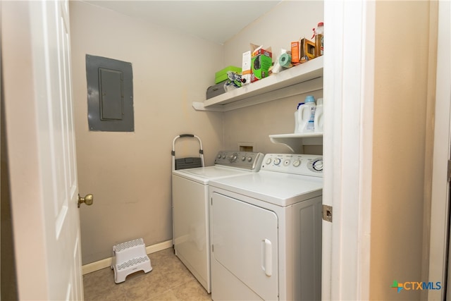 laundry room with electric panel, light tile patterned floors, and separate washer and dryer