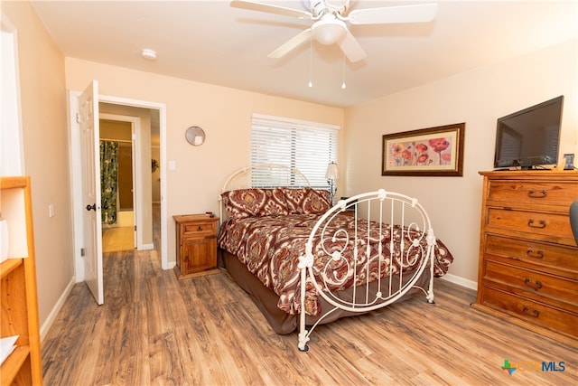 bedroom with hardwood / wood-style flooring and ceiling fan