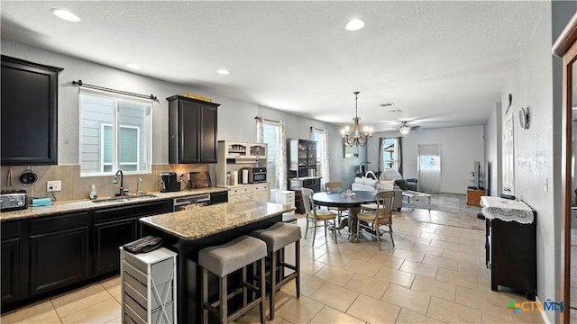 126 Texas Thistle, New Braunfels, TX 78130 - kitchen featuring open floor plan, plenty of natural light, light stone countertops, and recessed lighting
