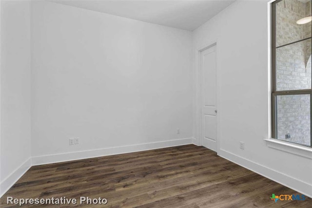 unfurnished room featuring dark hardwood / wood-style floors