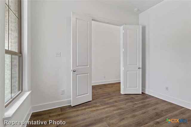 unfurnished bedroom featuring dark hardwood / wood-style floors