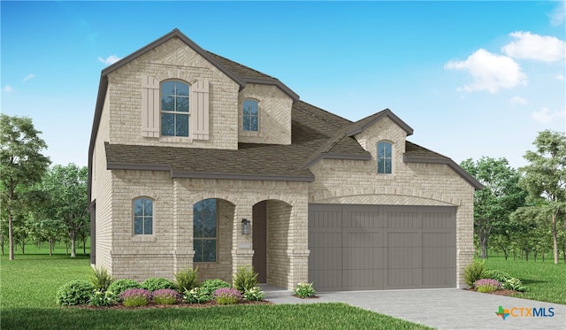 french country inspired facade featuring a garage and a front yard