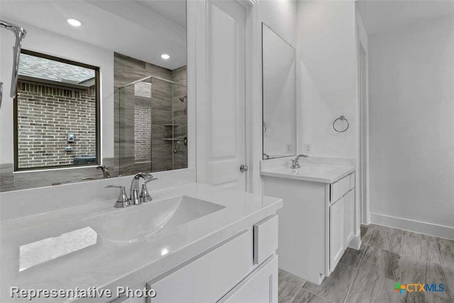 bathroom with vanity and a shower with door