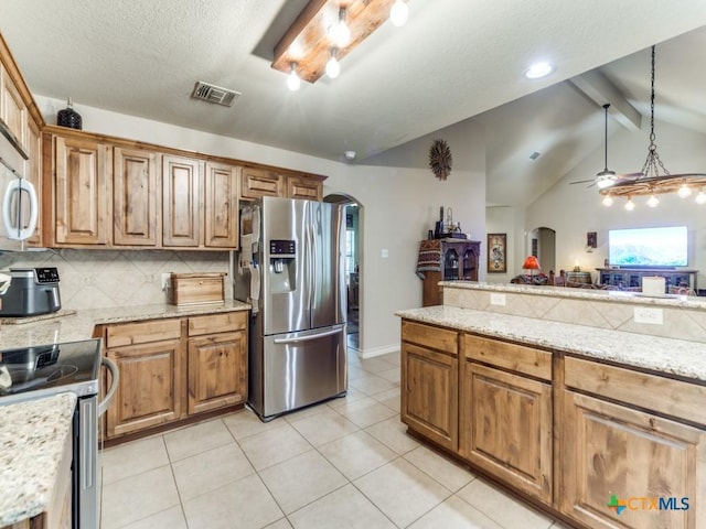 1777 Crossbow Dr, Canyon Lake, TX 78133 - kitchen featuring visible vents, a ceiling fan, tasteful backsplash, arched walkways, and appliances with stainless steel finishes