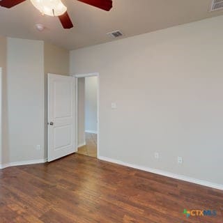 5120 Siltstone Loop, Killeen, TX 76542 - unfurnished room featuring a ceiling fan, wood finished floors, and baseboards