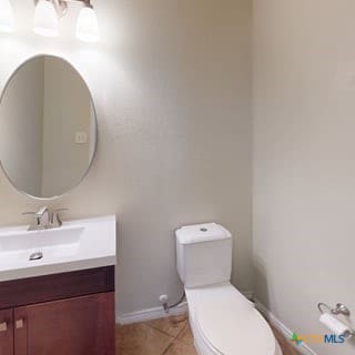 5120 Siltstone Loop, Killeen, TX 76542 - half bathroom featuring toilet, vanity, baseboards, and tile patterned floors