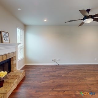 5120 Siltstone Loop, Killeen, TX 76542 - unfurnished living room with wood finished floors, baseboards, recessed lighting, a ceiling fan, and a fireplace with raised hearth