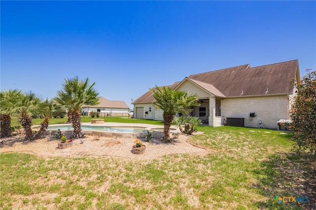 490 Wellspring Blvd, Victoria, TX 77904 - back of property featuring a lawn and an outdoor pool