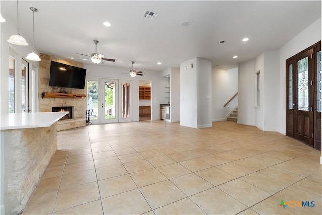211 Scarlett Ridge Dr, Boerne, TX 78006 - unfurnished living room featuring a fireplace, light tile patterned floors, recessed lighting, stairway, and ceiling fan
