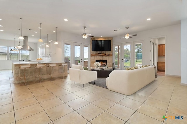 211 Scarlett Ridge Dr, Boerne, TX 78006 - living area featuring light tile patterned floors, a fireplace, recessed lighting, and a ceiling fan