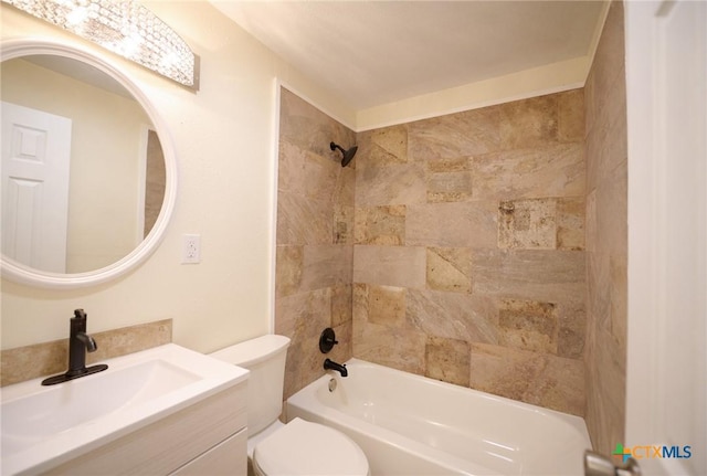 full bathroom featuring vanity, tiled shower / bath combo, and toilet