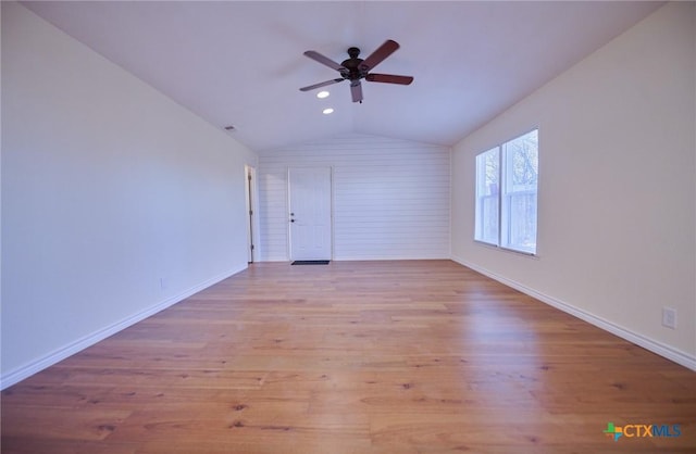 unfurnished room featuring light wood-type flooring, vaulted ceiling, and ceiling fan