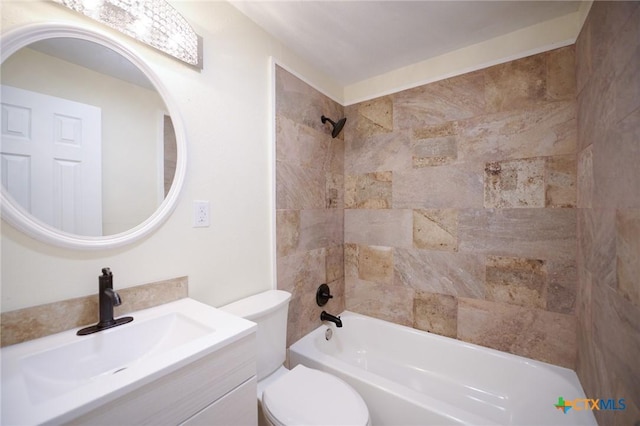 full bathroom featuring vanity, tiled shower / bath combo, and toilet