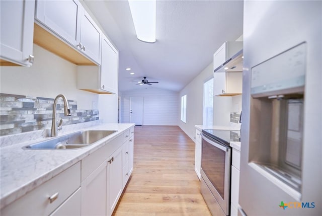 kitchen with white cabinetry, sink, ceiling fan, fridge, and electric stove