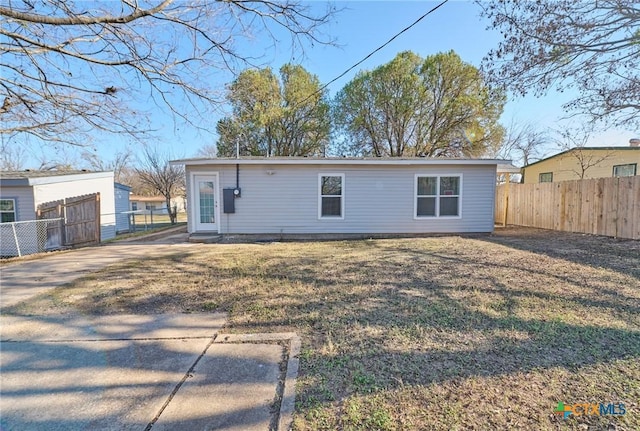 rear view of house with a lawn