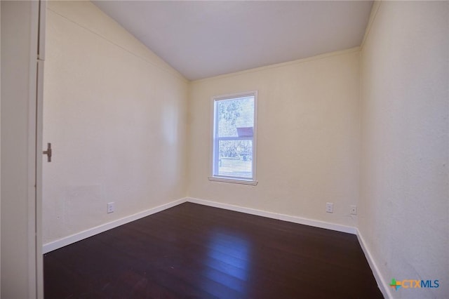 spare room featuring hardwood / wood-style floors and crown molding