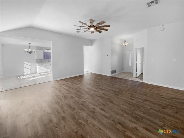 unfurnished living room featuring ceiling fan with notable chandelier, vaulted ceiling, sink, and light hardwood / wood-style flooring