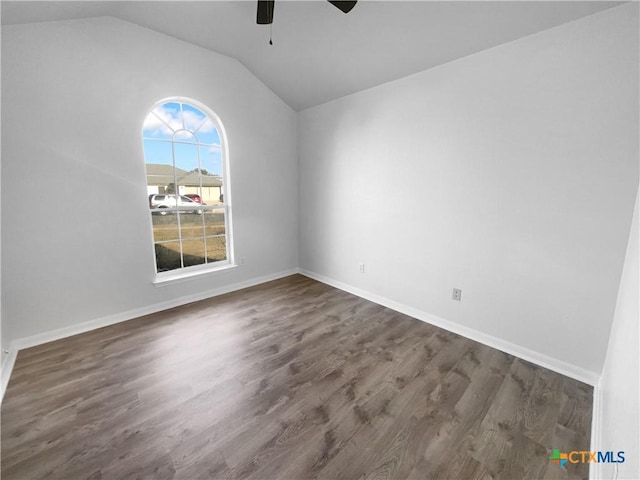 unfurnished room featuring ceiling fan, dark hardwood / wood-style flooring, and vaulted ceiling