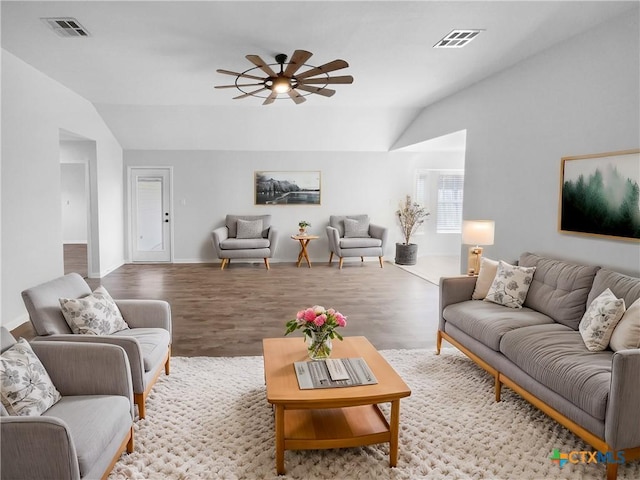 living room featuring ceiling fan, light hardwood / wood-style floors, and vaulted ceiling