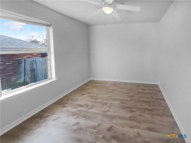 empty room featuring ceiling fan and hardwood / wood-style floors