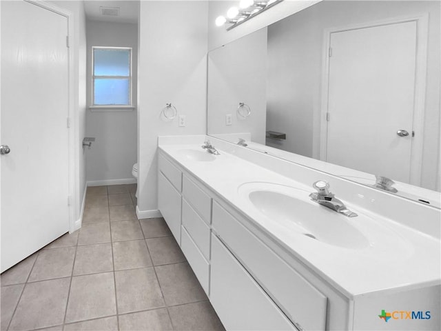 bathroom with tile patterned floors, vanity, and toilet