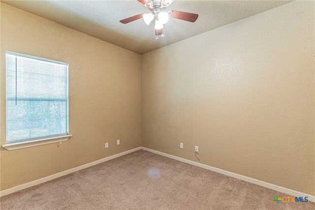 carpeted empty room with ceiling fan