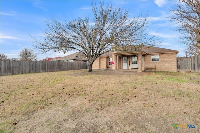 back of property featuring a yard