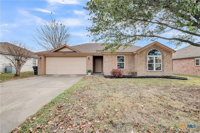 single story home with a front yard and a garage