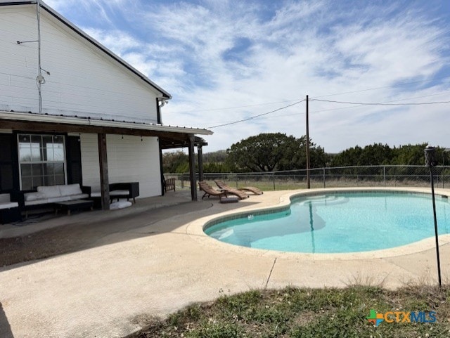 view of pool with a patio area, an outdoor living space, a fenced in pool, and fence