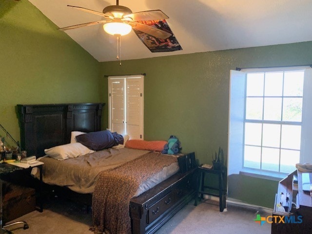 bedroom featuring baseboards, carpet floors, lofted ceiling, and ceiling fan