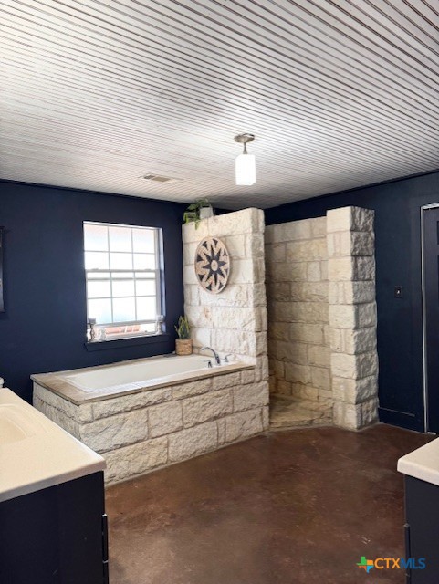 full bathroom featuring a bath, visible vents, vanity, and concrete floors