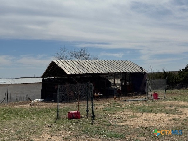 view of pole building with fence