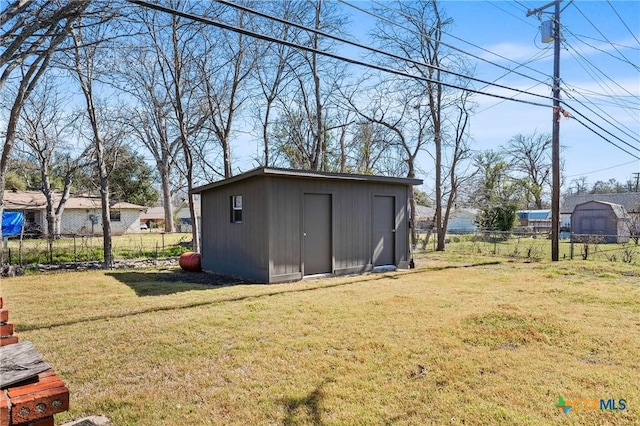 view of shed featuring fence