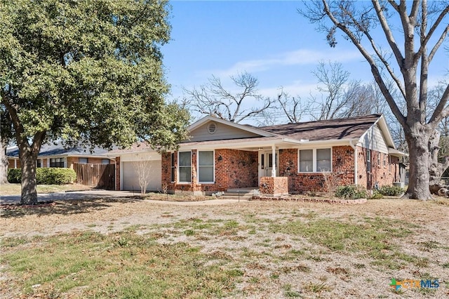 ranch-style house featuring a garage, a front yard, fence, and brick siding