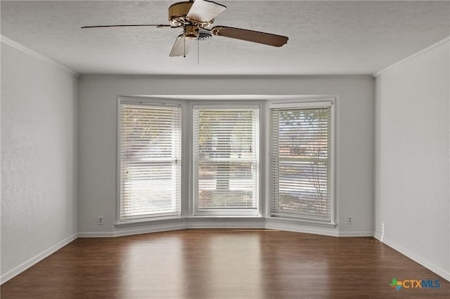 empty room with a healthy amount of sunlight, a textured ceiling, ornamental molding, and wood finished floors