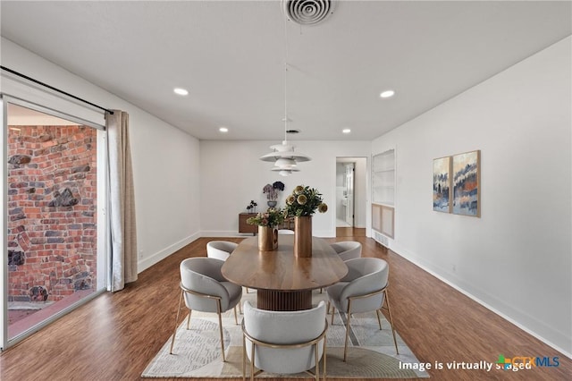 dining space featuring built in shelves, recessed lighting, wood finished floors, visible vents, and baseboards