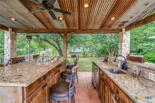 view of patio / terrace with ceiling fan and an outdoor wet bar